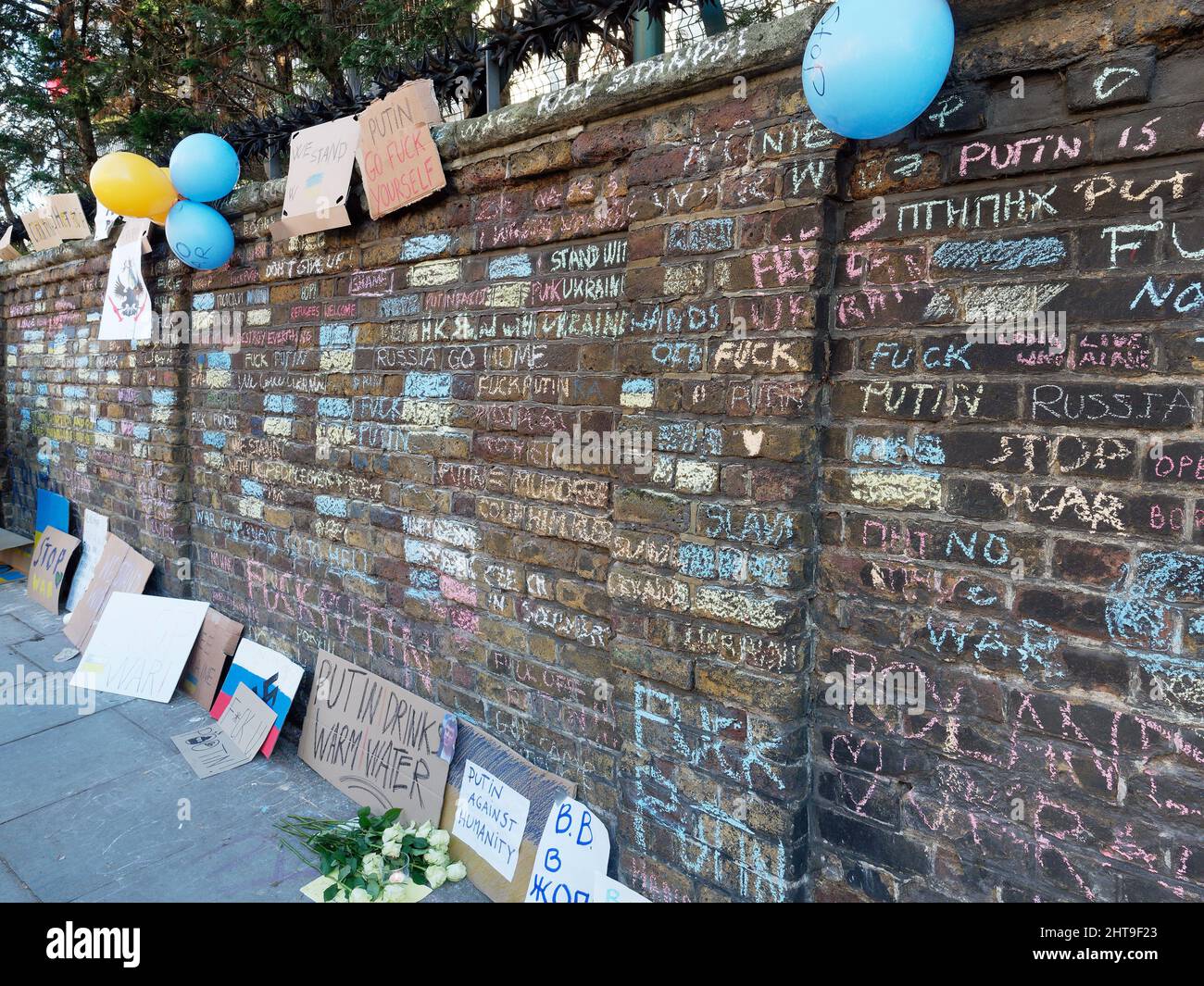 View of a wall at the Russian Consulate in London covered in graffiti and placards to protest at the Russian invasion of Ukraine Stock Photo