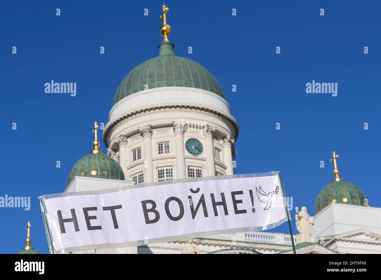 Helsinki, Finland - February 26, 2022: Demonstrator in a rally against Russia’s military actions and occupation in Ukraine carrying sign No to war. Stock Photo