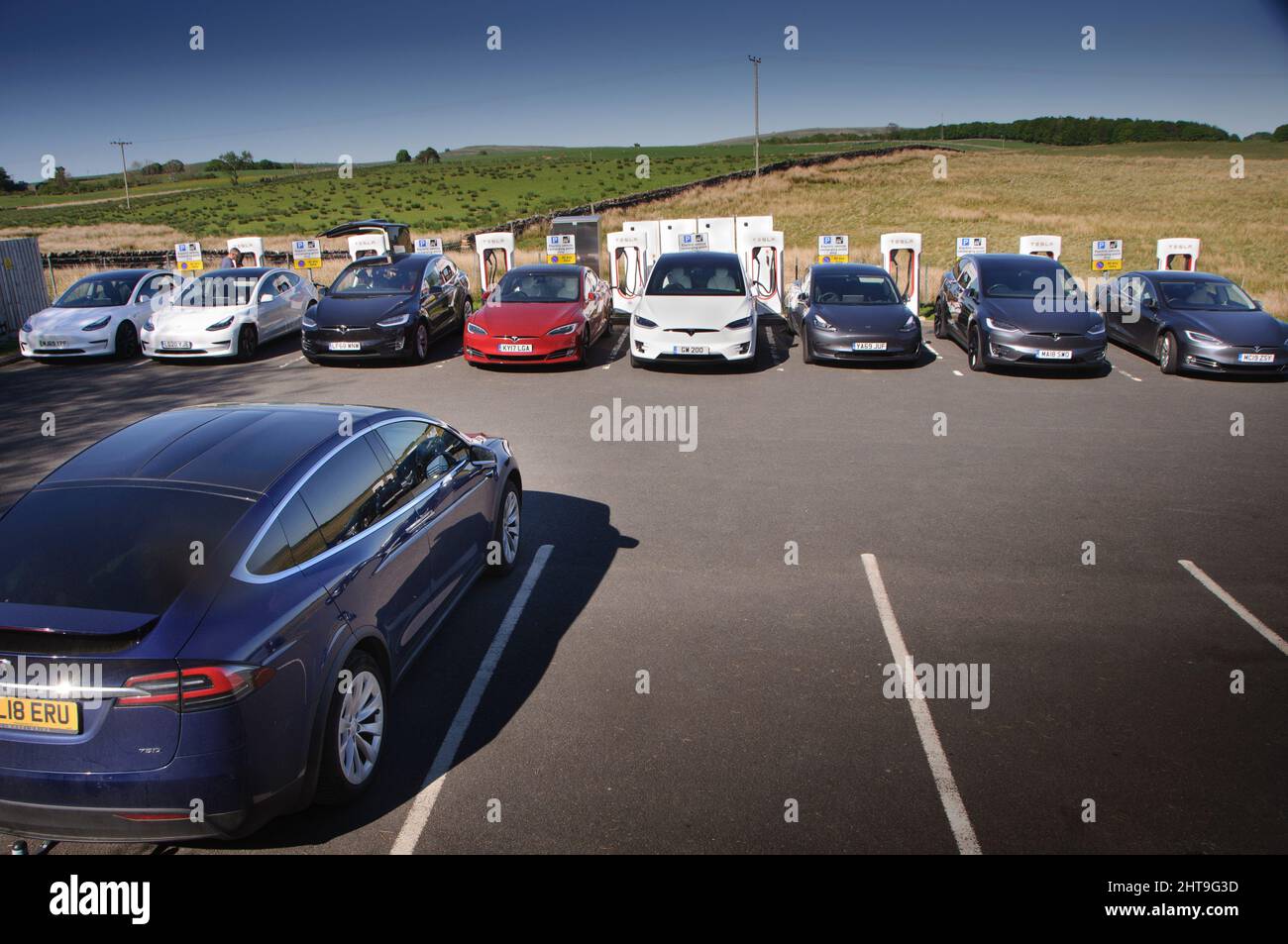 Tesla electric cars parked at charging points located at the Tebay