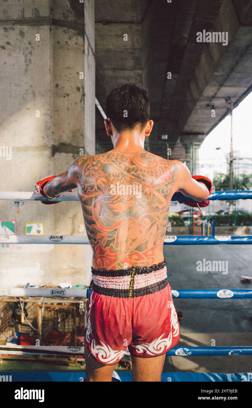 Young maithai boxer stands with his completely tattooed back to the camera  Stock Photo - Alamy, image size:861x1390
