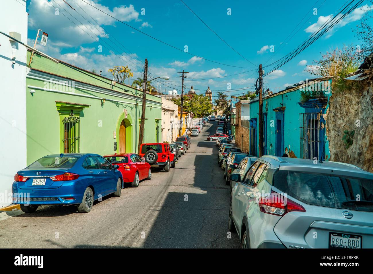 Street photography of parked cars and houses in the colonial style and