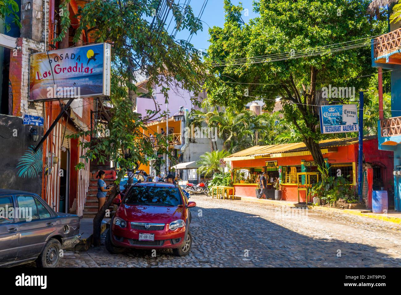Street photography of cars and buildings in the magic town of Sayulita