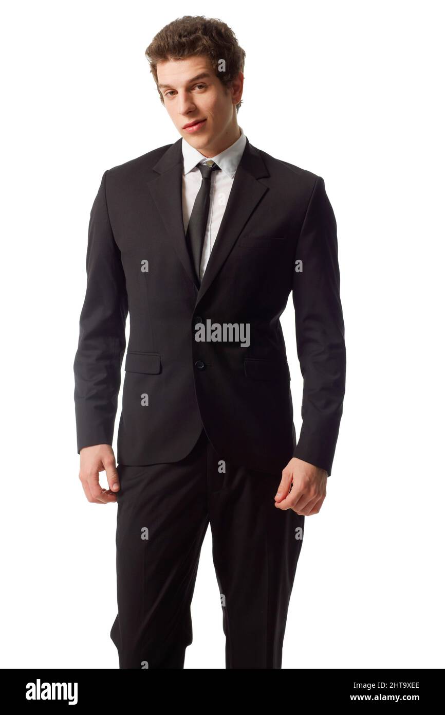 Young and confident. A confident young man standing in a suit against a ...