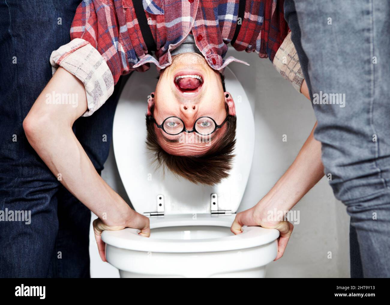 Hes an easy target. Closeup portrait of a nerdy guy getting dunked in the  school toilet Stock Photo - Alamy