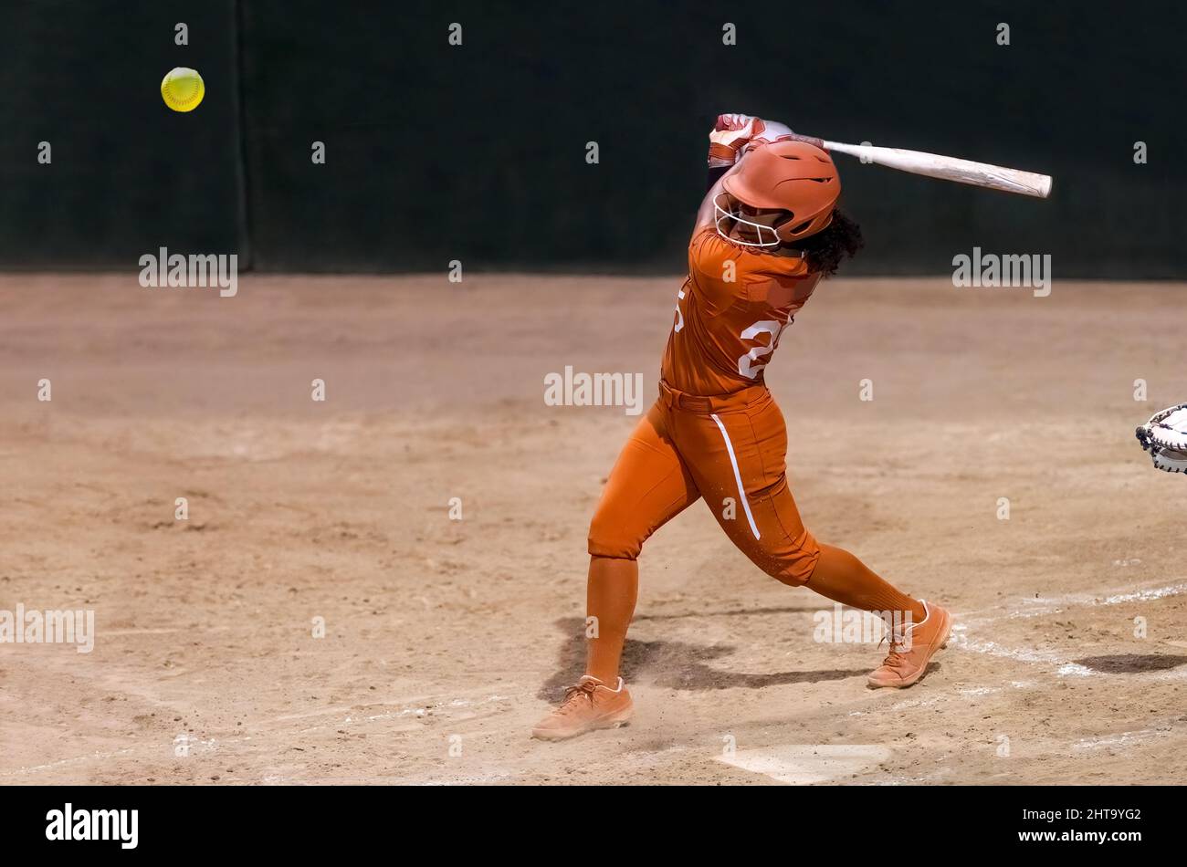 A Softball Player College Athlete Is Swinging The Bat In Perfect Form