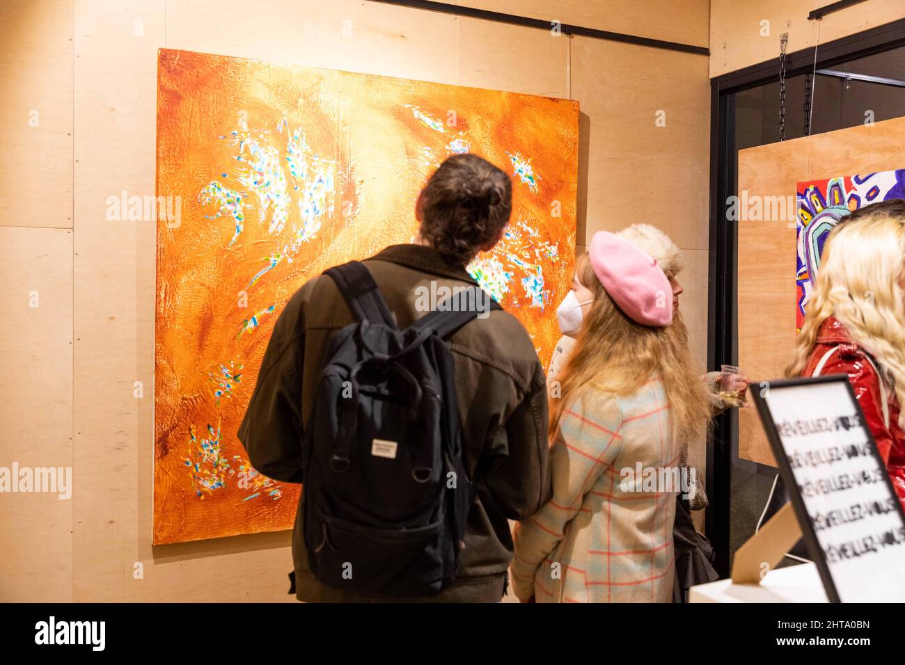 Audience during an art exhibition opening in the vibrant Stock Photo Alamy