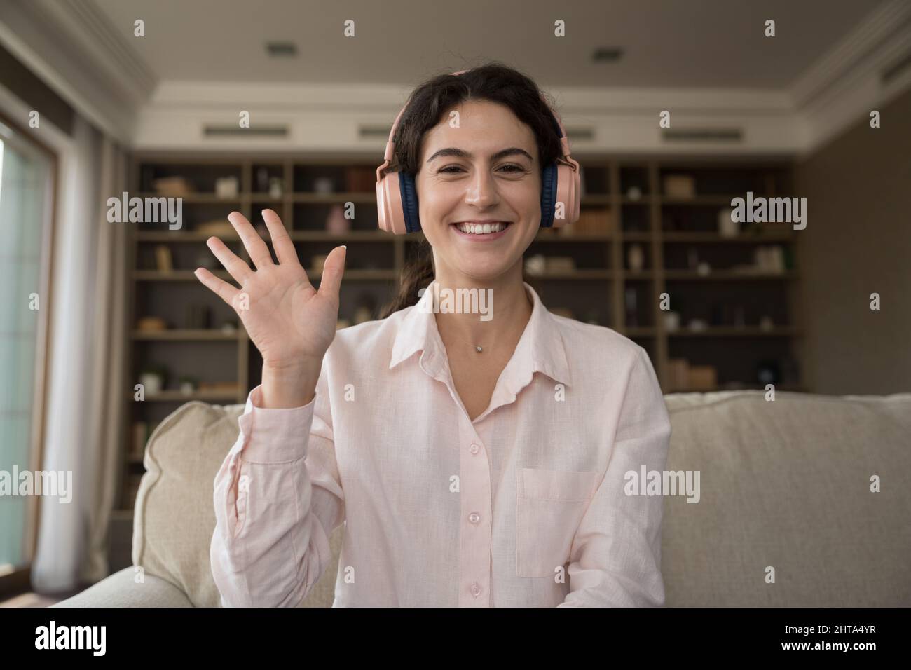 Web camera view cheerful millennial Hispanic woman starting video call. Stock Photo