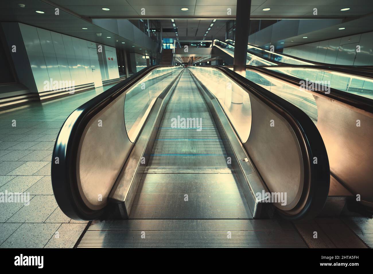Front view of a chrome flat moving walkway in a subway or an office. Focus on an entrance on a travelator in an international airport or a mall; stair Stock Photo
