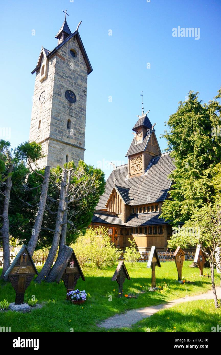 Vertical shot of a tower and church building by a park Stock Photo - Alamy