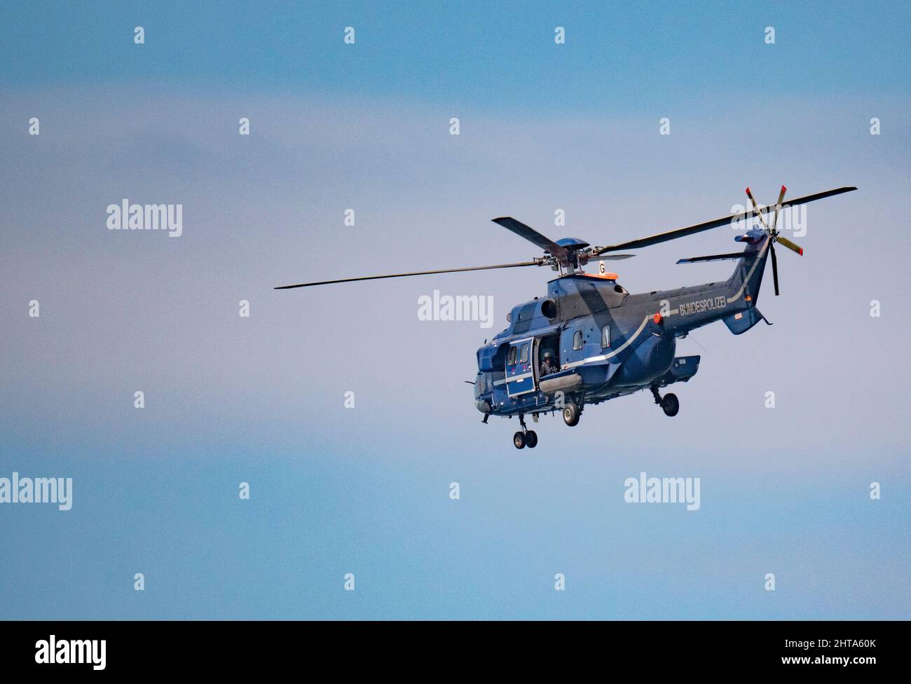 German Federal Police helicopter in flight Stock Photo
