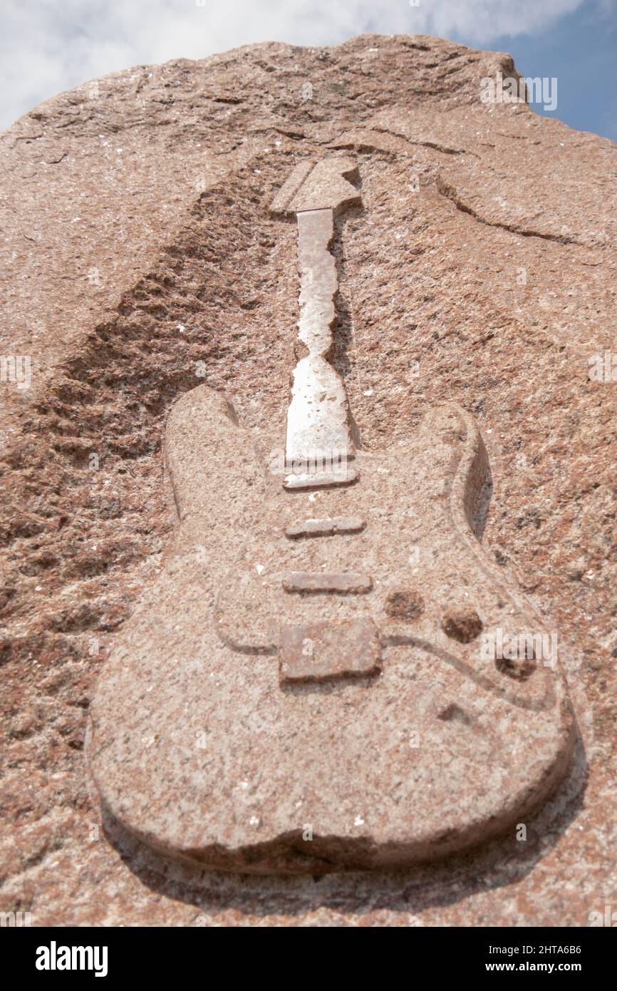 Isolated electric guitar of Jimi Hendrix memorial stone in Fehmarn Stock Photo