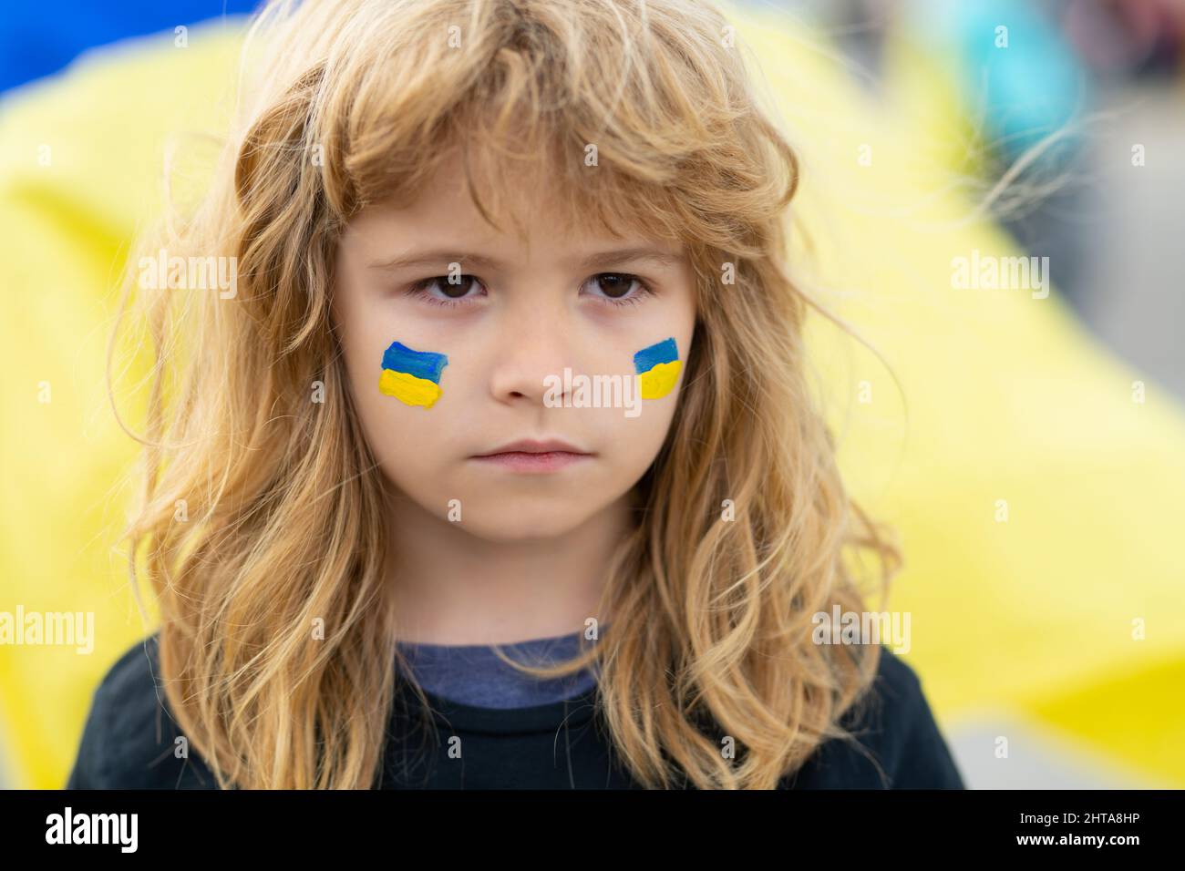 Ukraine flag on children cheeks. Human protest. Stock Photo