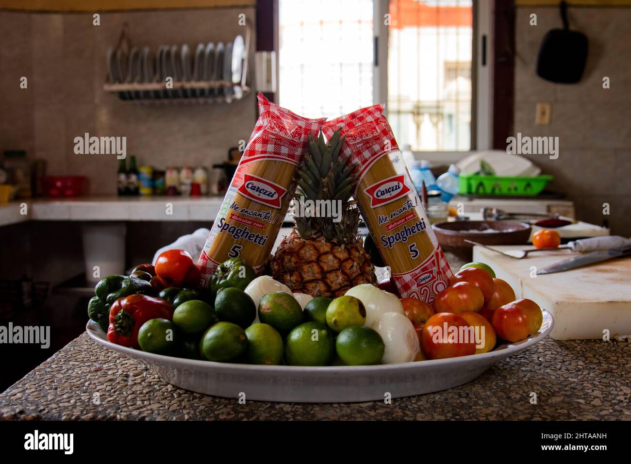 Bowl of fresh colorful fruits and spaghetti in a kitchen at a restaurant in Havana, Cuba. Stock Photo