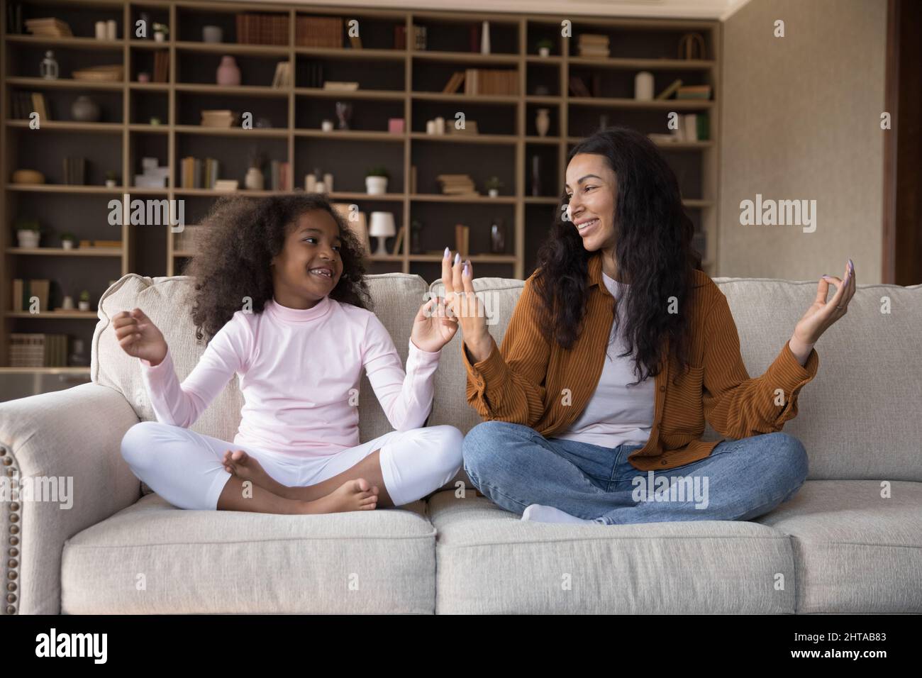 Happy African American mother and daughter doing yoga exercises Stock ...