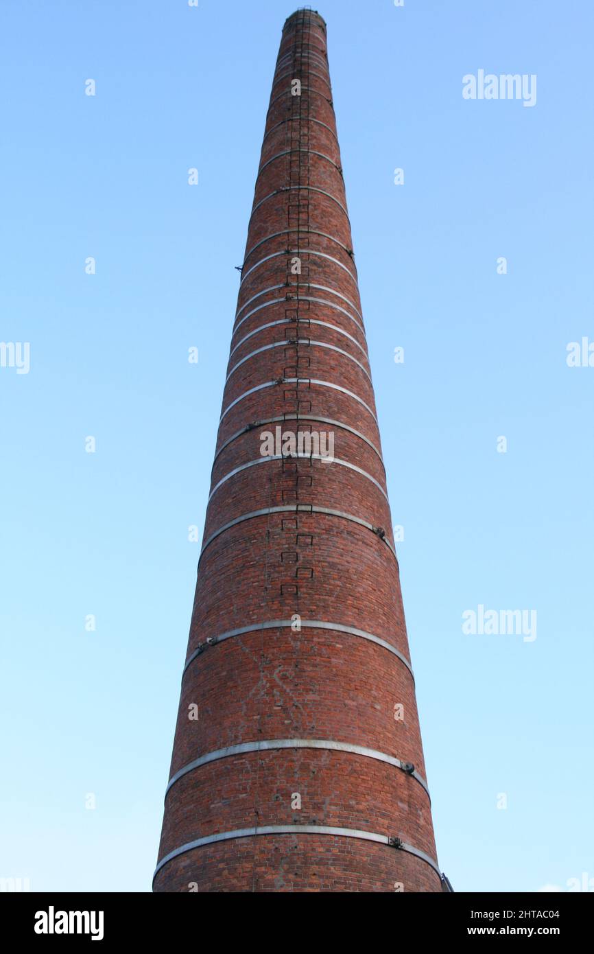 Low angle shot of a brick chimney against a cloudy sky Stock Photo - Alamy