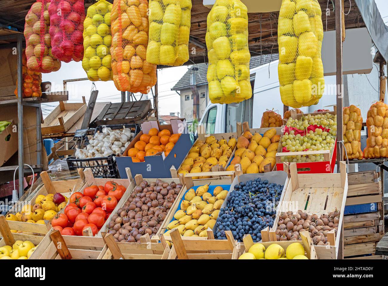Fresh organic raw fruits and vegetables inside cardboard and wooden ...