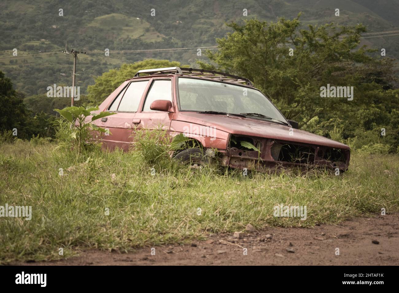 Front view of an old damaged broken red car parked in nature Stock ...