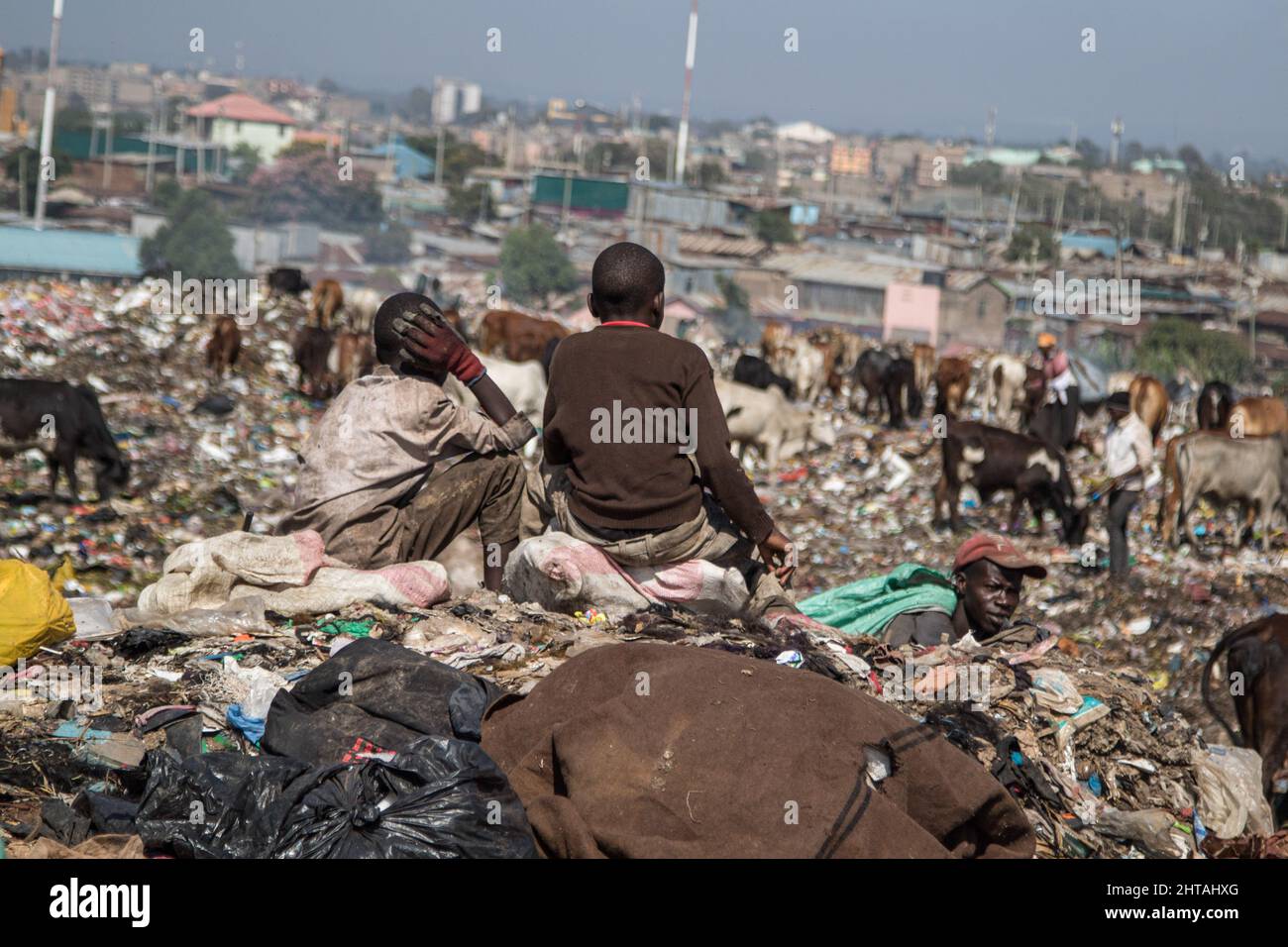 Two boys sit on nylon sacks at Dandora Dumping site. Discussions to chart a way forward for a
