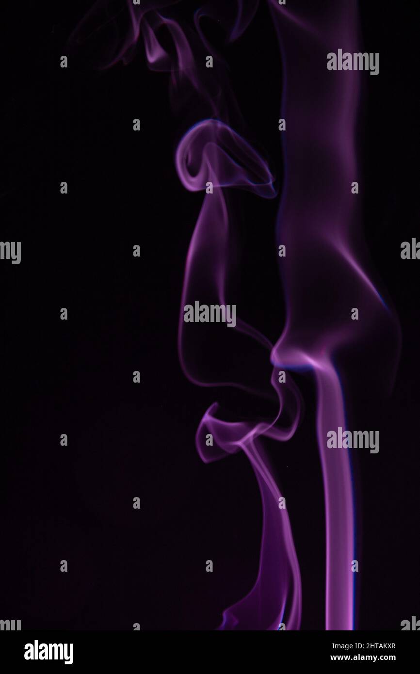 Real colorful smoke on black background. Graphic resource for use with blend modes. Fusion layers. Stock Photo