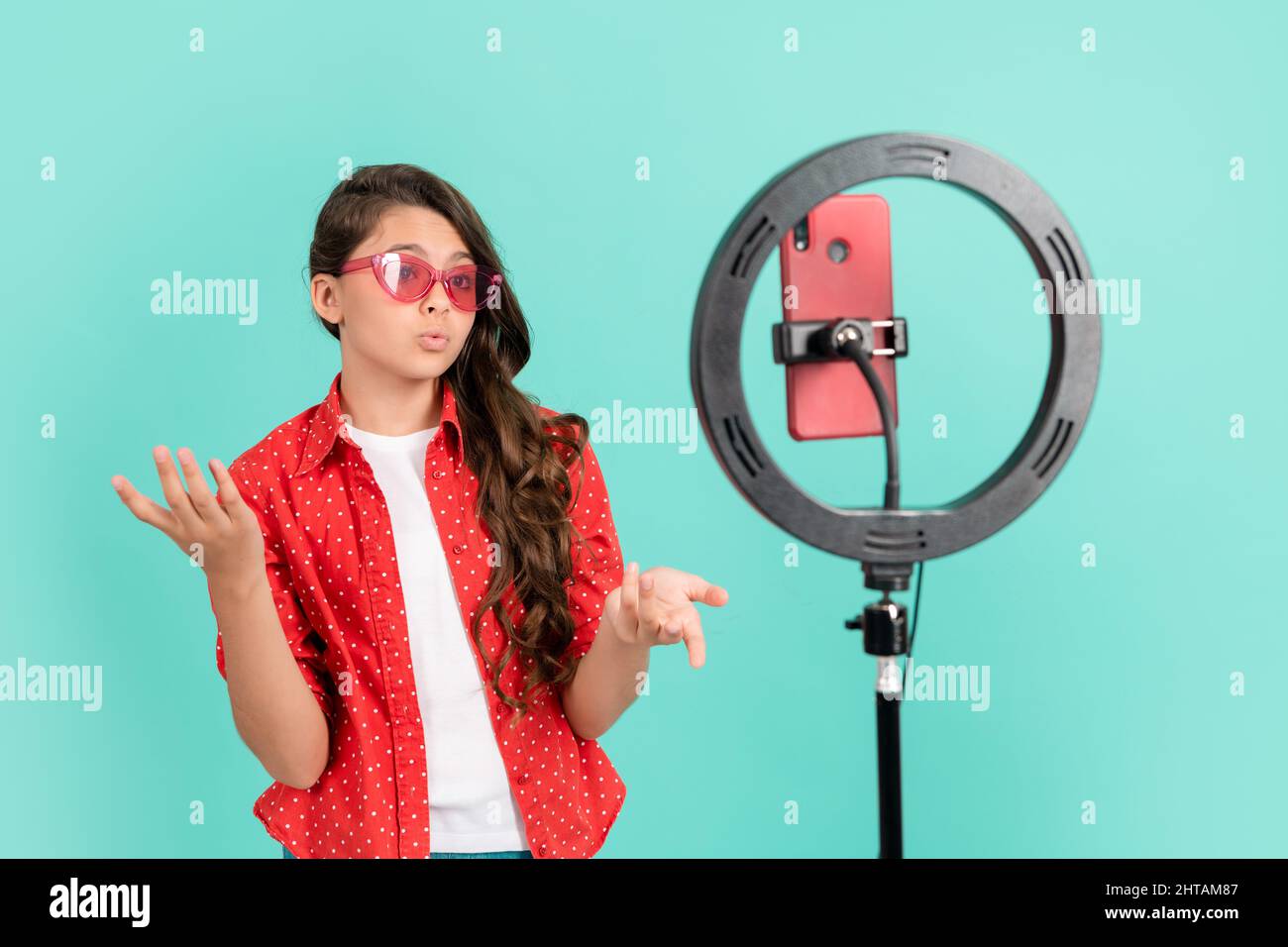 serious teen girl talking on camera video blog blogging online with