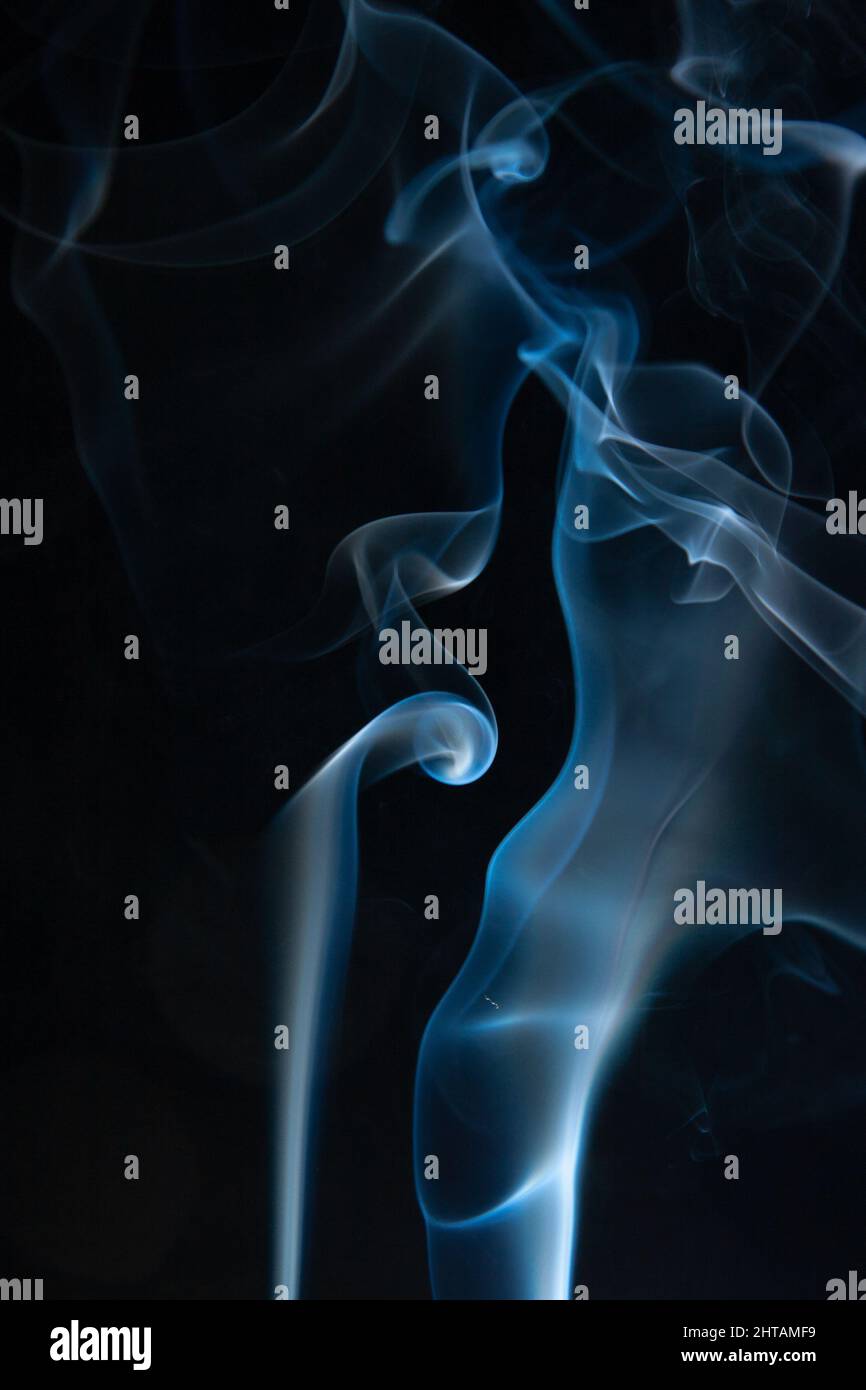 A closeup of a colorful smoke on black background Stock Photo - Alamy