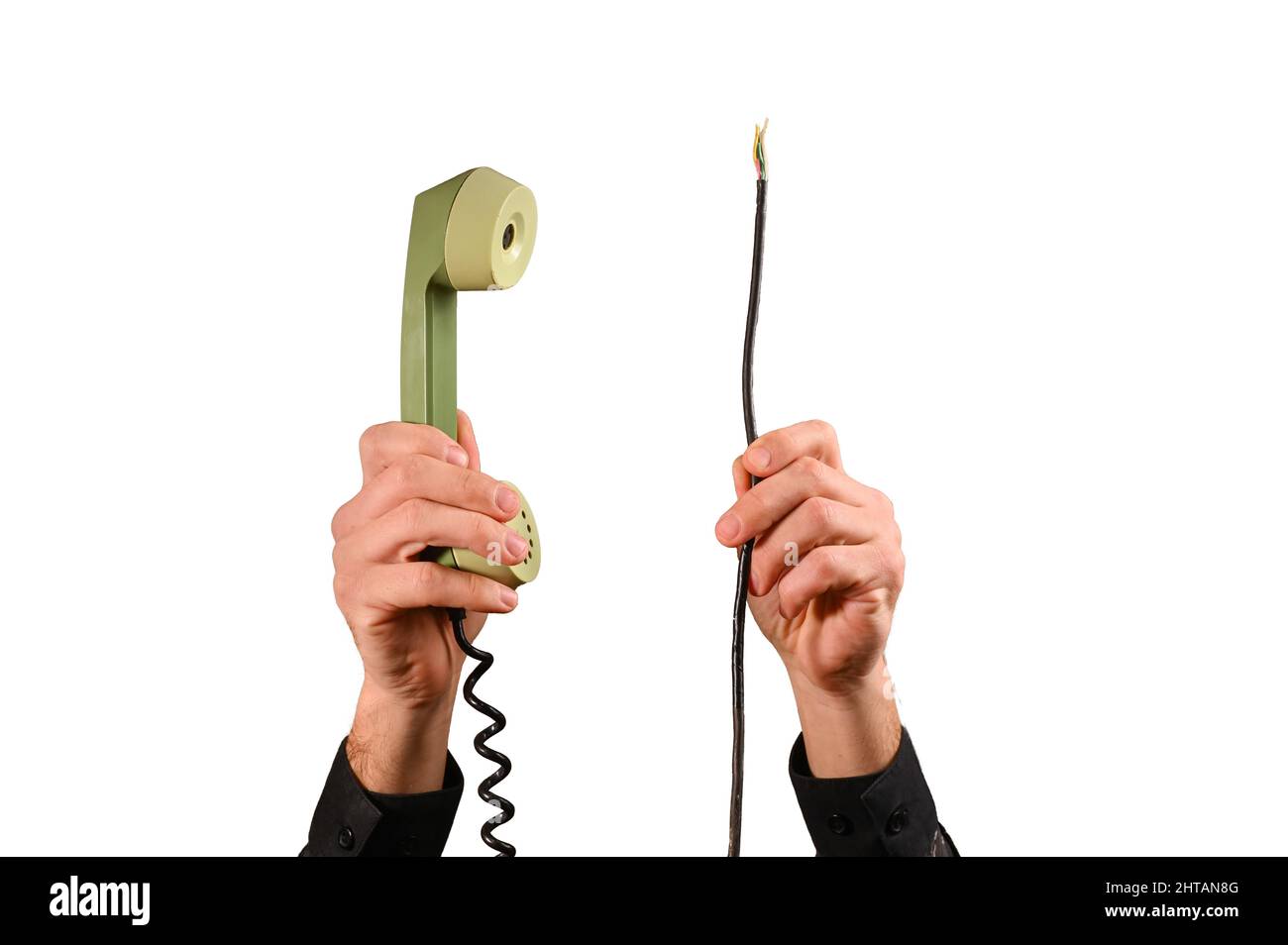 a telephone receiver in his hand and broken wires. isolated on a white background Stock Photo