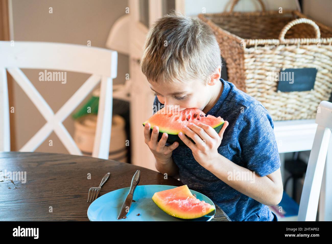 Little boy eating a watermelon with pleasure Stock Photo