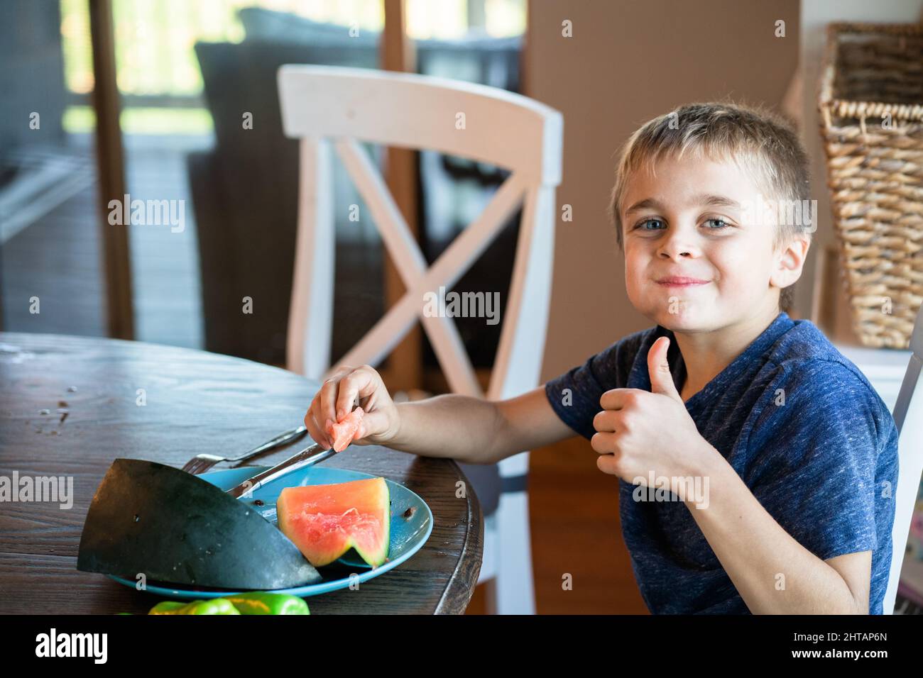 Little boy eating a watermelon with pleasure Stock Photo