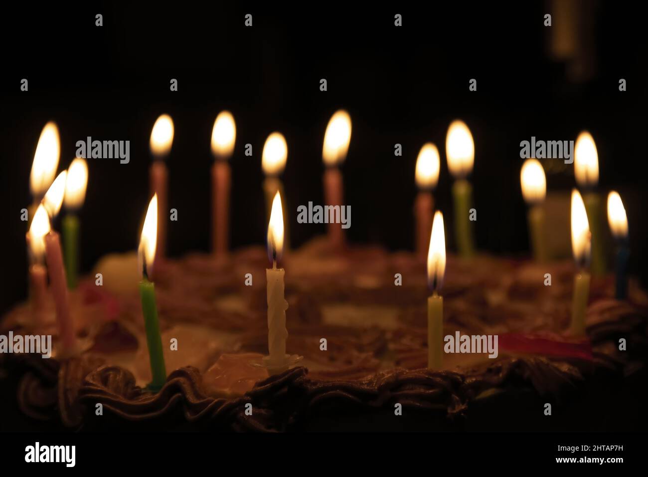 Closeup of a birthday cake with lighting candles in the dark room Stock ...