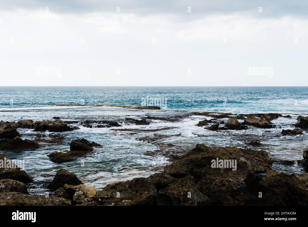 North Pacific oceanside with waves washing the rocks in Hawaii Stock ...