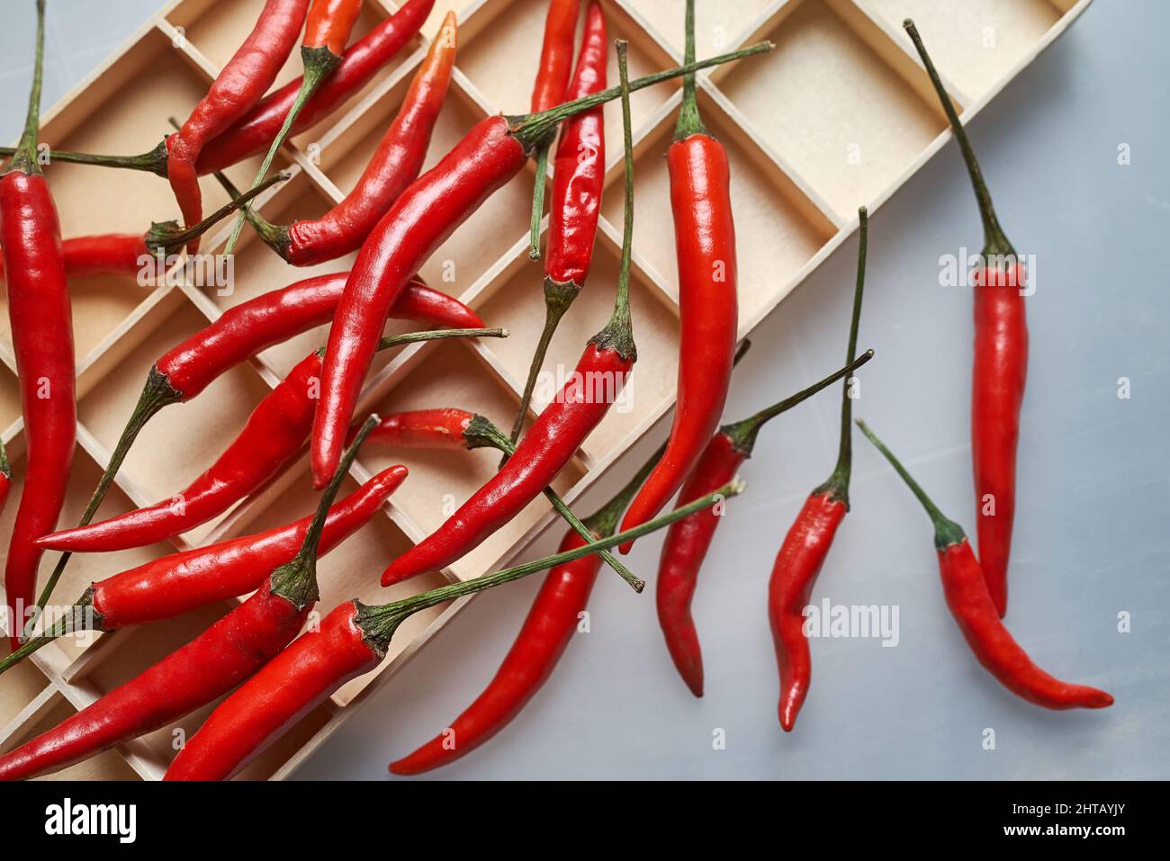 Red chili peppers on the wooden tray Stock Photo - Alamy