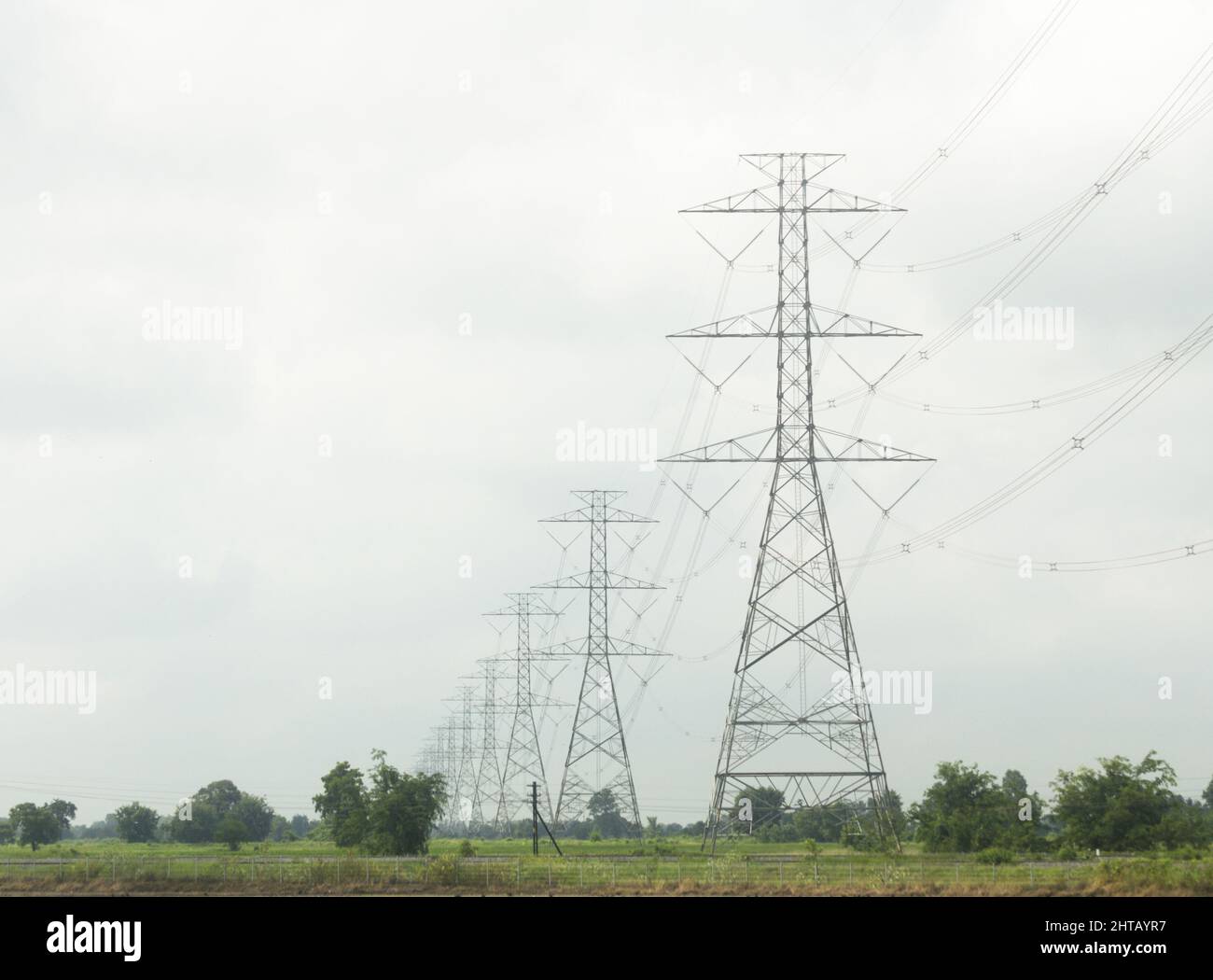 Photo of power lines on a cloudy day Stock Photo - Alamy
