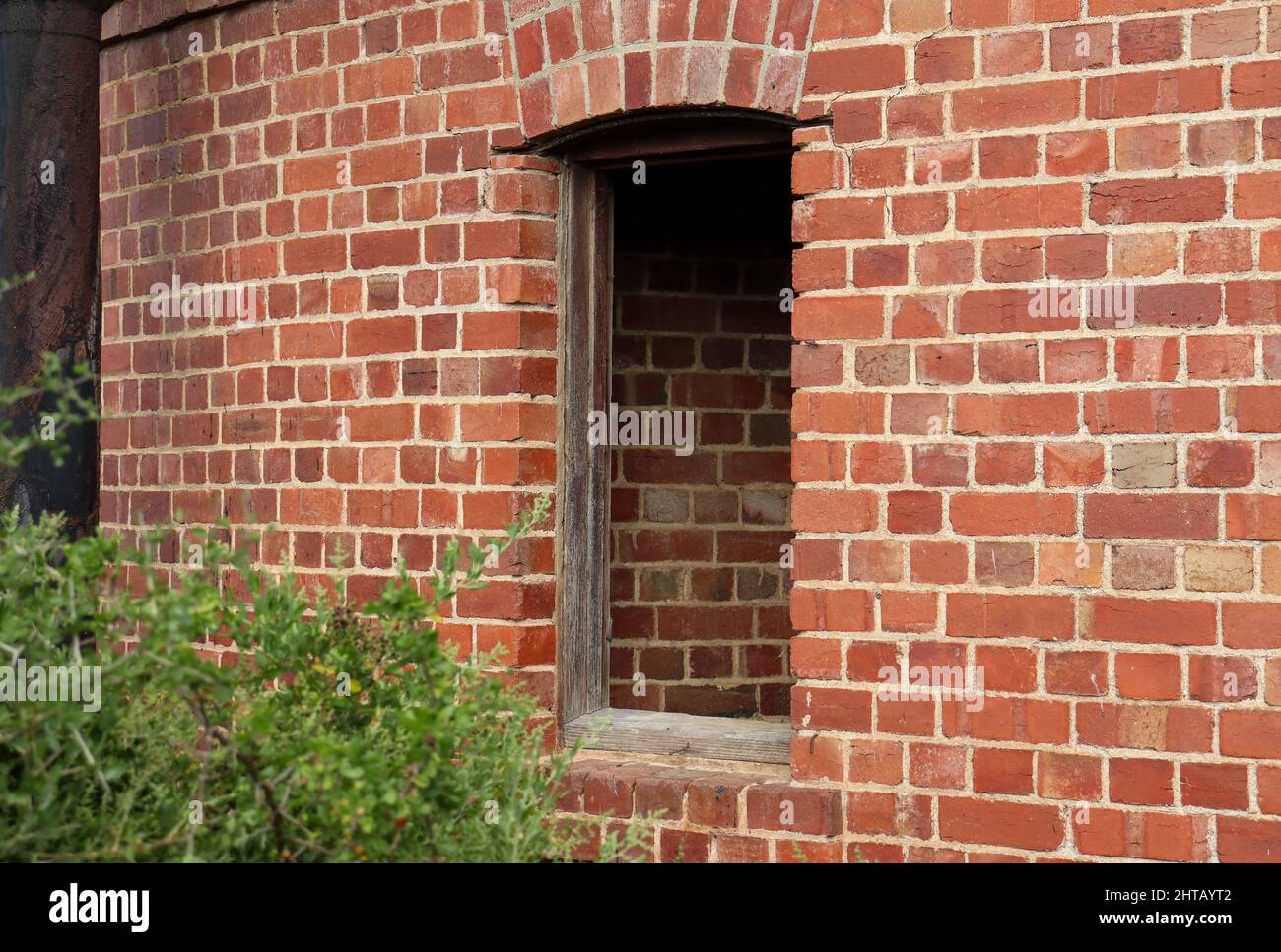 Photo of a brick wall and a window without panels Stock Photo - Alamy