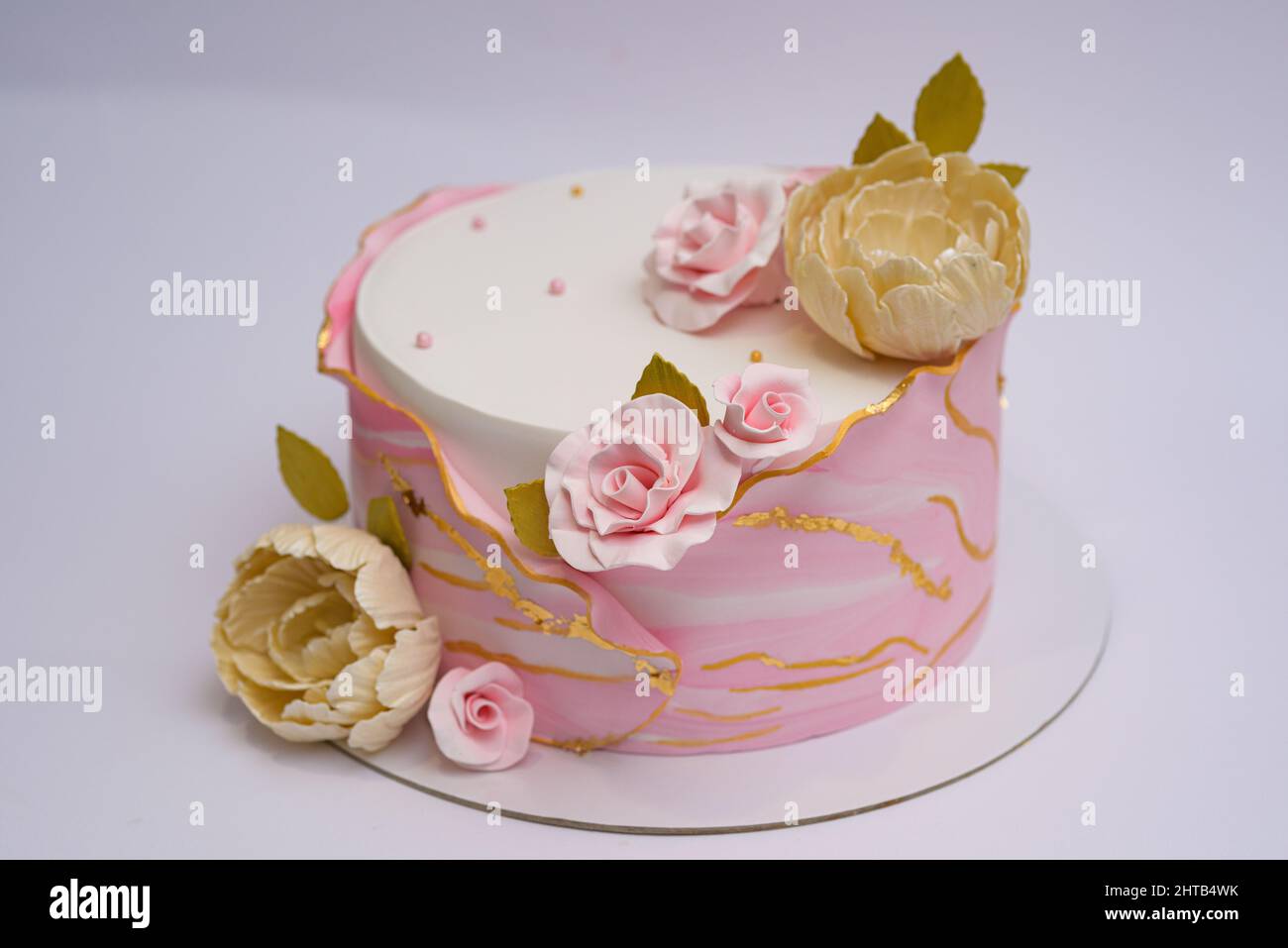 Photo of floral pink and white cake design on a white background Stock