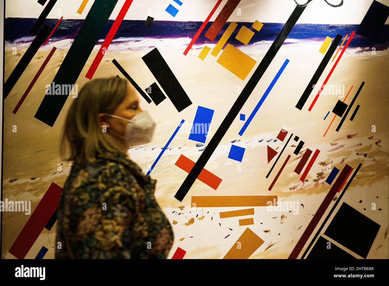 A visitor observes a painting of Carlos Azaneda exhibited at SAM