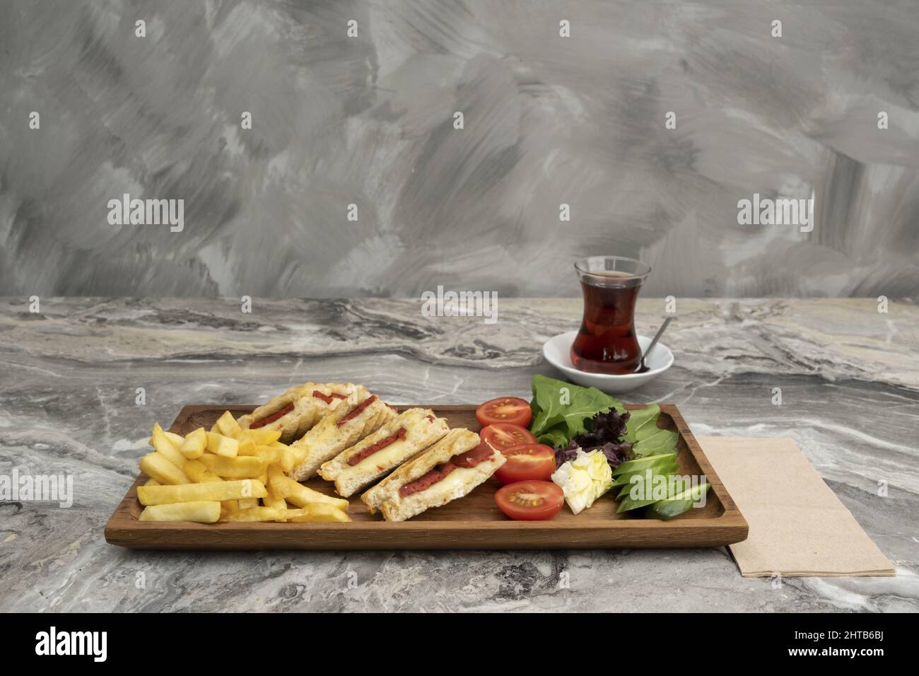 Toast in wooden serving platter on marble background Stock Photo