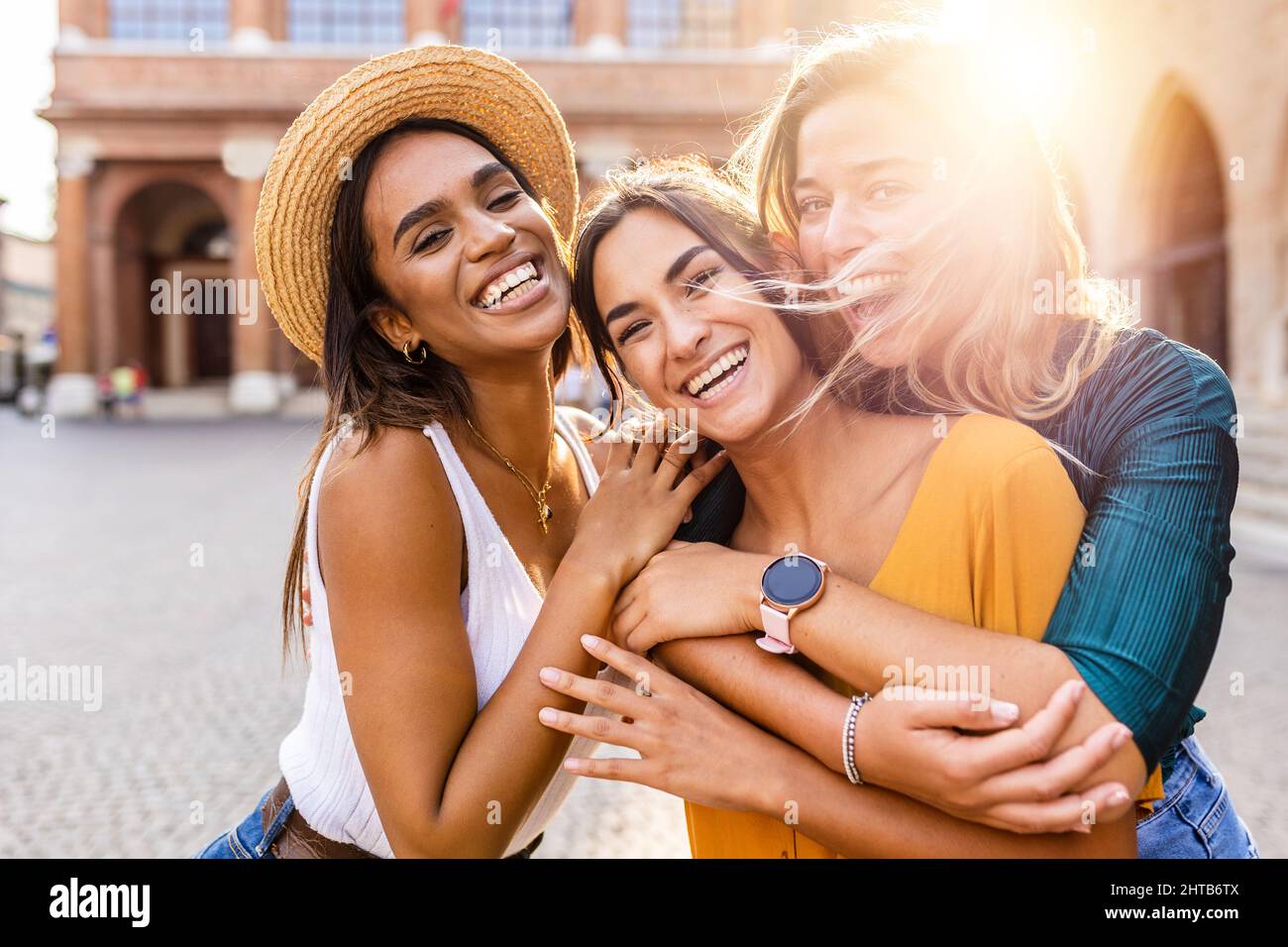 Happy group of beautiful young women laughing together outdoors Stock Photo