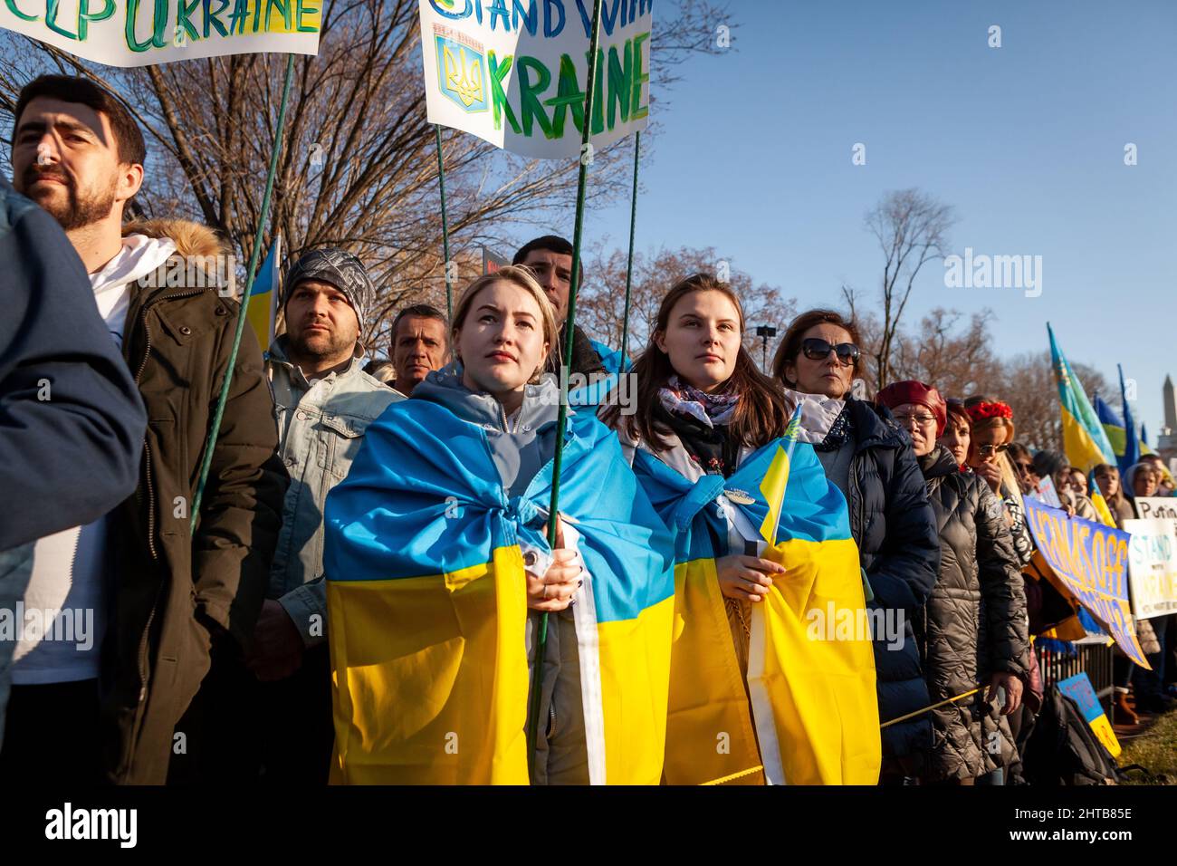 Washington, DC, USA, 27 February, 2021.  Pictured: Protesters wearing Ukrainian flags attend a rally at the White House.  Thousands of people from across the United States gathered to thank the US and other countries for their help, and to demand a no-fly zone and other assistance for Ukraine.  The event was sponsored by United Help Ukraine and US Ukrainian Activists, both U.S.-based assistance and advocacy organizations.  Credit: Allison Bailey / Alamy Live News Stock Photo