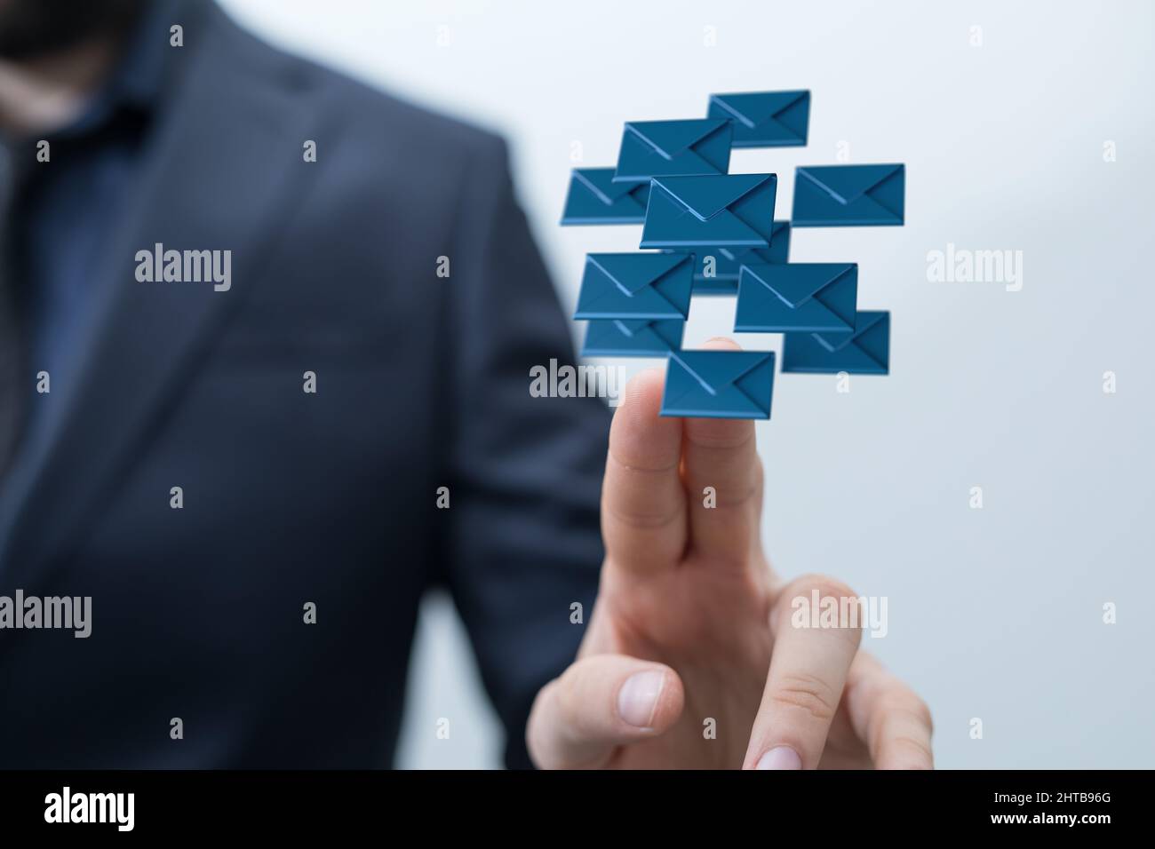 3D rendering of blue email icons in the air with a businessman holding ...