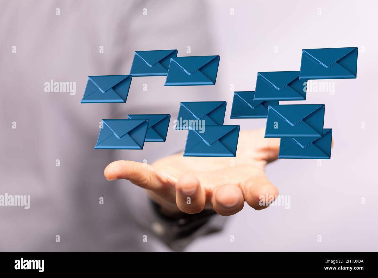 Closeup of a person holding illustrative digital message icons with a ...