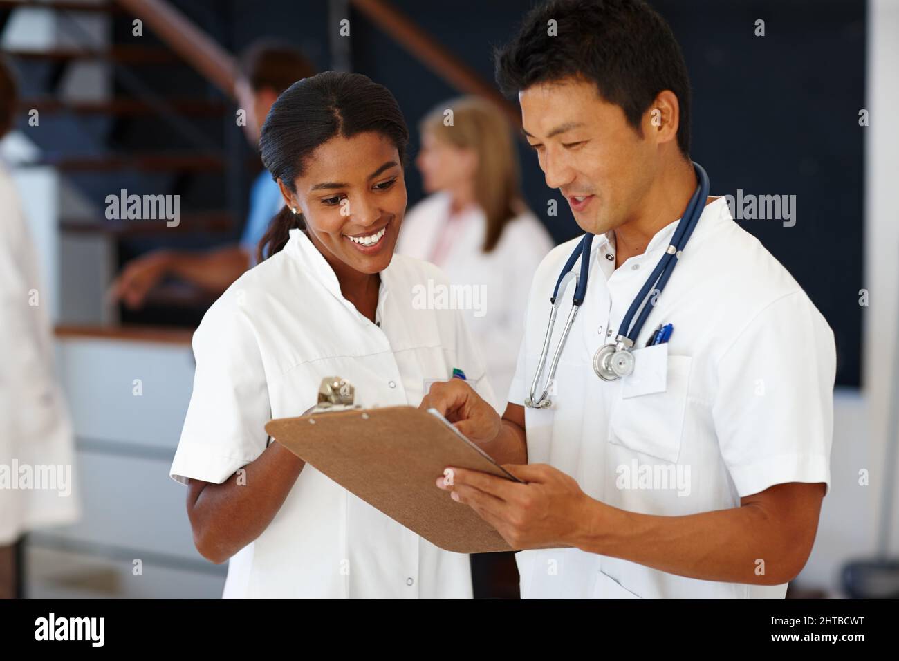 Helping others to get better is our goal. Shot of two doctors dicussing patient diagnosis. Stock Photo