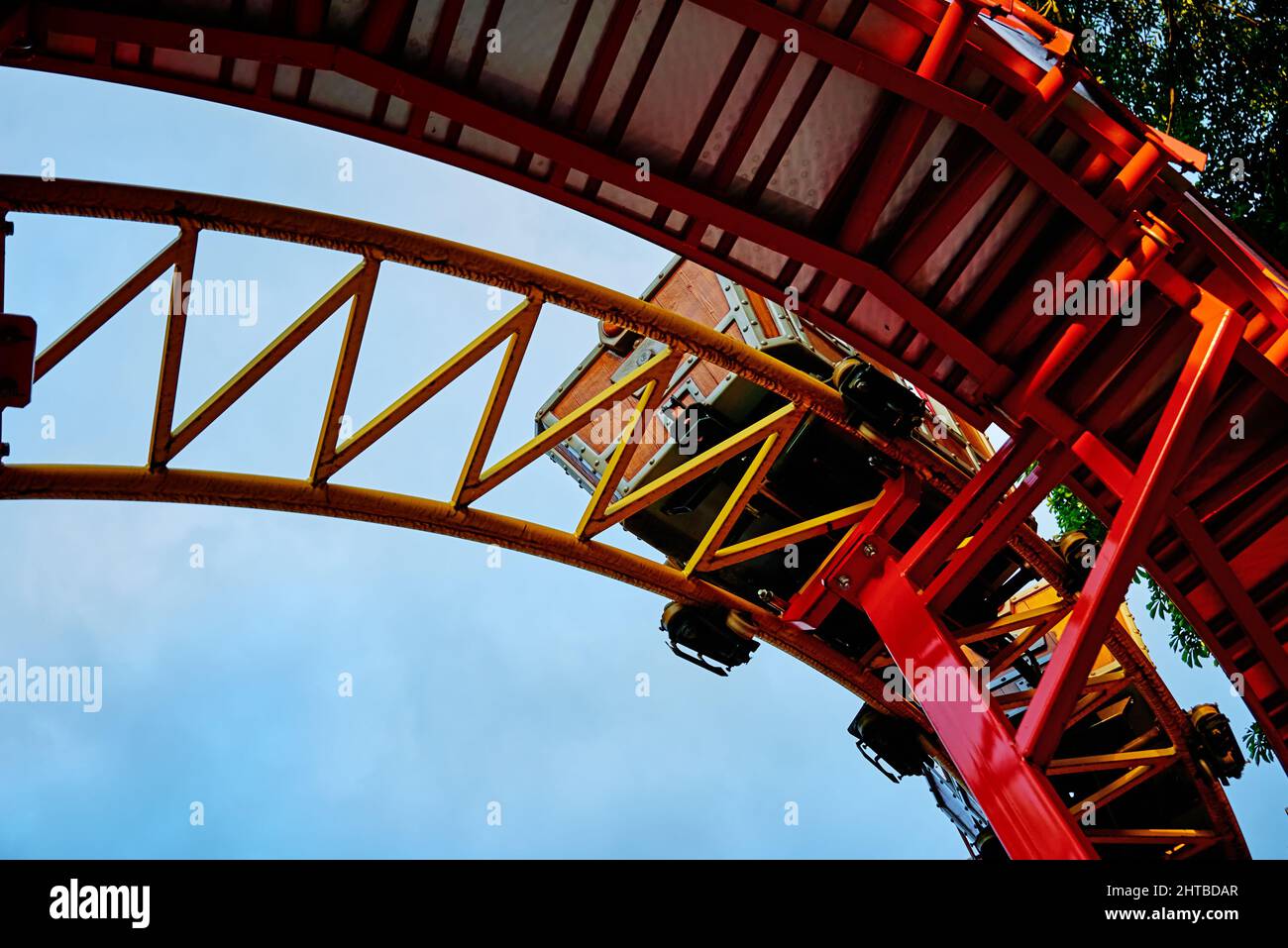 Part of looping roller coaster at summer day, Riding a rollercoaster at amusement park Stock Photo
