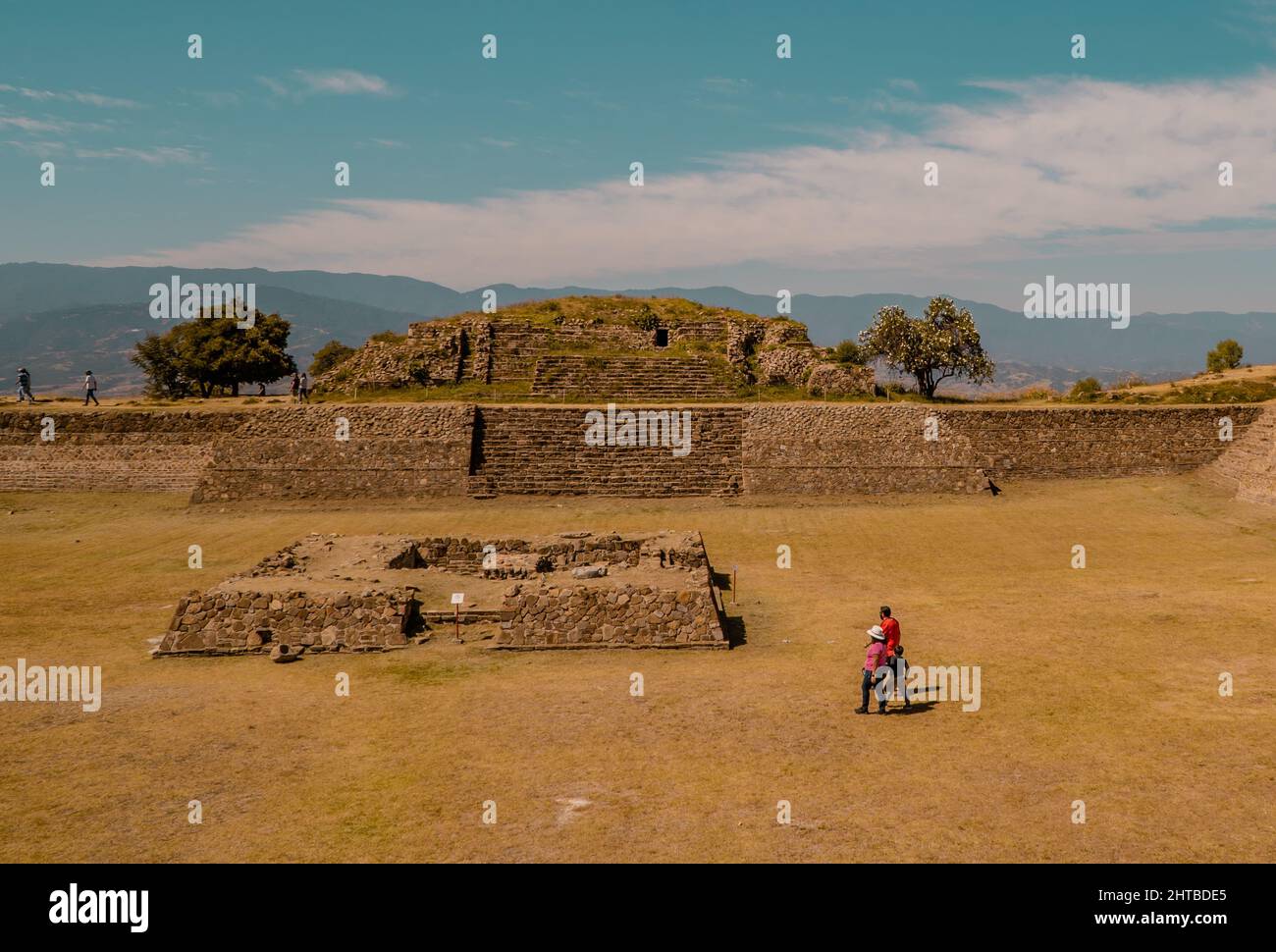 Zapotec temples with tourists inside the Monte Alban archaeological