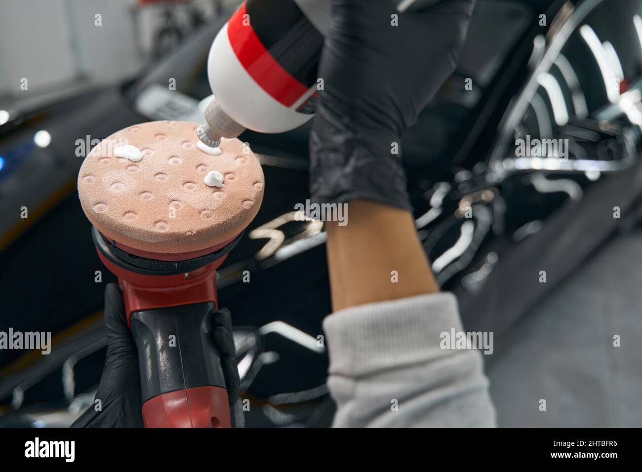Car detailer putting buffing compound on polishing head Stock Photo Alamy