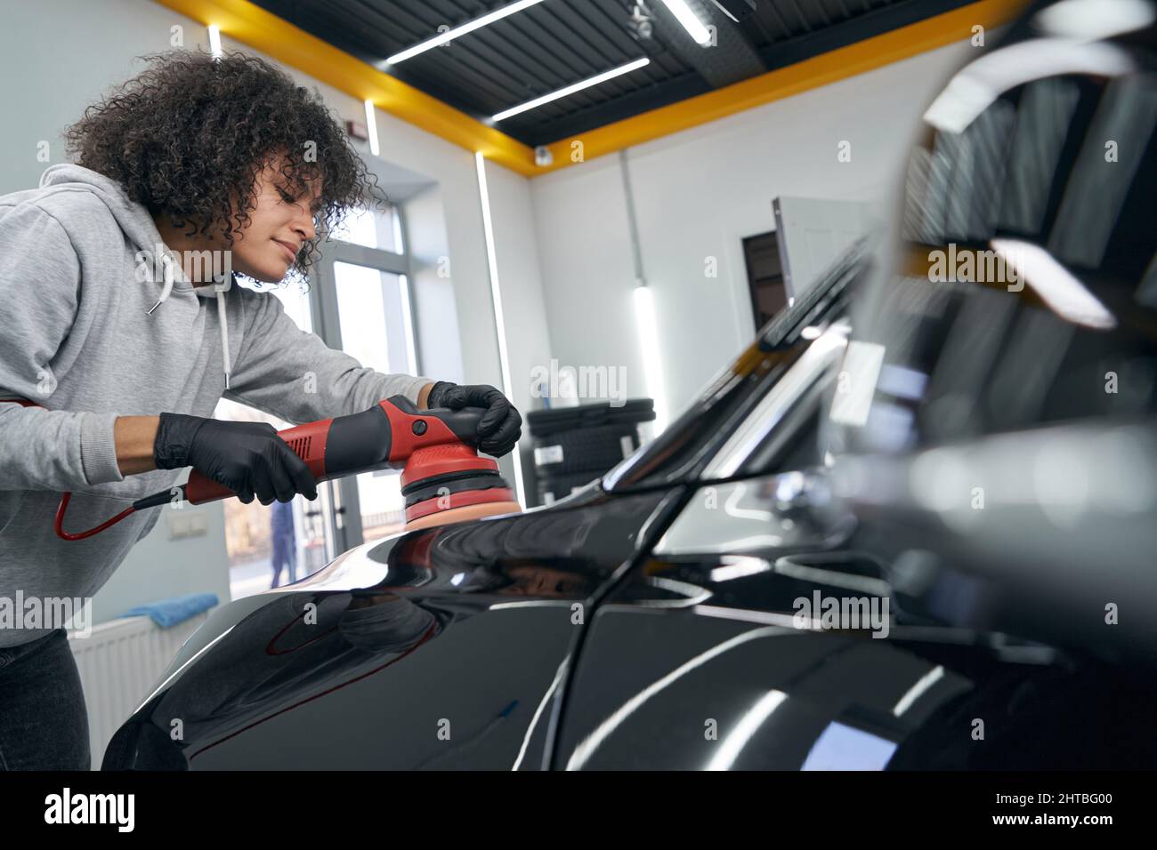 Focused calm car detailer polishing auto hood Stock Photo Alamy