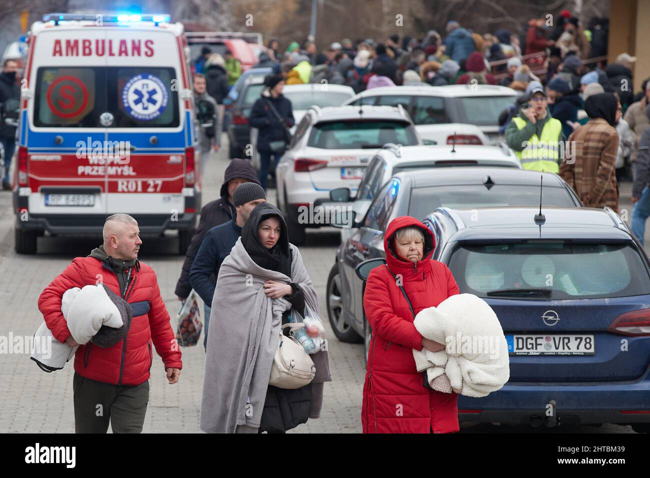 Przemysl, Poland. 27th Feb, 2022. People walk out of the customs at the Przemysl railway station in Przemysl, Poland, Feb. 27, 2022. Recently, a large number of Ukrainian people arrived in Przemysl by train. Credit: Meng Dingbo/Xinhua/Alamy Live News Stock Photo