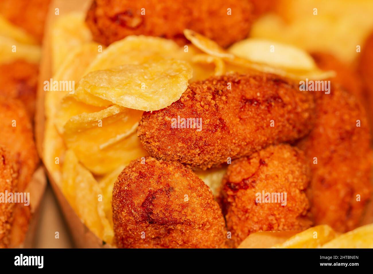 Closeup of Ham croquettes with french fries at the Boqueria market in