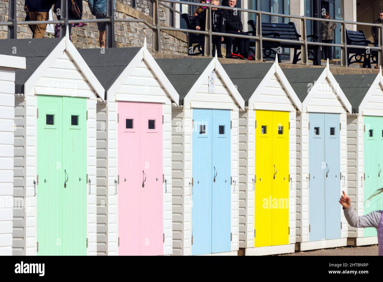 multi coloured wooden beach huts in pastel colours on the seafront at