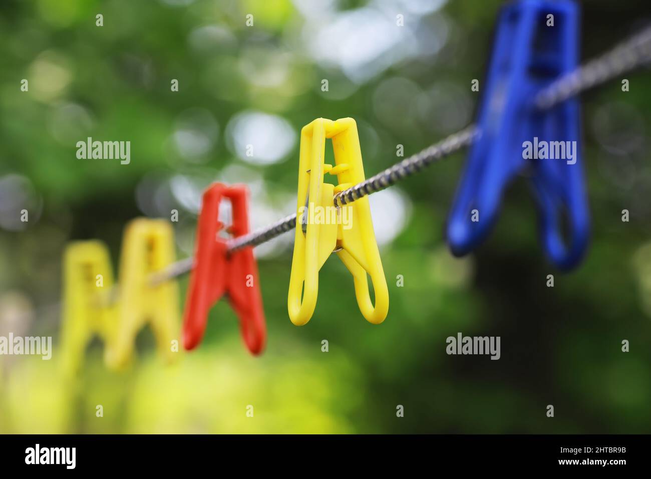 Clothespins on a clothesline in summer. Dry clothes outside. Clothes on