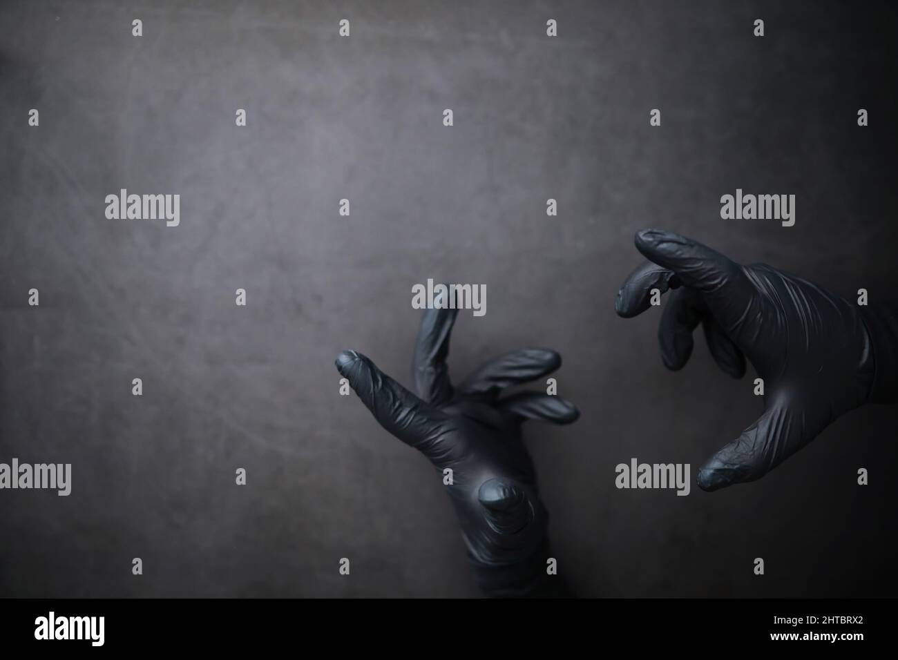 Background of hands in gloves. Black gloves. Hand gestures black gloves